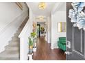 Bright and airy foyer with hardwood floors and a staircase at 7977 Rudder Cir, Fairburn, GA 30213