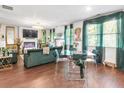 Open living space with green velvet sofas and a glass dining table at 7977 Rudder Cir, Fairburn, GA 30213