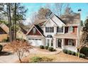 Two-story house with stone accents and a landscaped yard at 9921 Between The Grns, Villa Rica, GA 30180