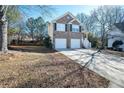 Two-story brick home with a two-car garage and a driveway at 2770 Stony Place Ct, Grayson, GA 30017