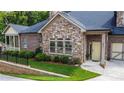 Stone and brick townhome with landscaped yard and two-car garage at 4821 Josie Way, Acworth, GA 30101