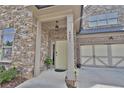 Inviting front entrance with light yellow door and stone accents at 4821 Josie Way, Acworth, GA 30101