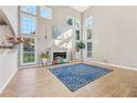 Bright living room with a fireplace and wall-to-wall windows at 575 Maple Crest Dr, Lawrenceville, GA 30044