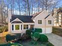 Charming two-story home featuring a well-maintained lawn and an attached two-car garage at 1379 Chatley Way, Woodstock, GA 30188