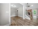 Open-concept living room showcases a cozy fireplace, and an abundance of natural light at 321 Evie Ln, Canton, GA 30115
