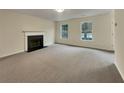 Living room with fireplace and neutral carpeting at 7391 Petal Pl, Fairburn, GA 30213