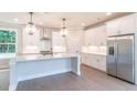Modern kitchen with white cabinetry, quartz countertops, and stainless steel appliances at 2626 Radvell Ct, Decatur, GA 30034