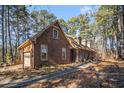 Brick home showcasing a side view with attached garage at 5275 Johnson Spur, Loganville, GA 30052