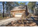 Detached brick garage with driveway and landscaping at 5275 Johnson Spur, Loganville, GA 30052