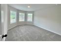 Spacious bedroom with bay window and grey carpet at 67 Longhorn Way, Auburn, GA 30011