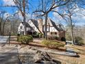 Brick home with a large backyard, surrounded by mature trees at 2402 Highway 138 Sw, Conyers, GA 30094