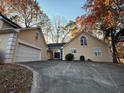 Tan house with a two-car garage and mature trees at 4342 White Surrey Nw Dr, Kennesaw, GA 30144