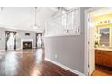 Bright living room features hardwood floors, a fireplace, and staircase access to the upper level at 7492 Ferrara Dr, Lithonia, GA 30058