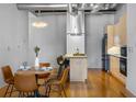 Open concept kitchen with stainless appliances and hardwood floors next to a cozy dining area at 1058 Piedmont Ne Ave # 302, Atlanta, GA 30309