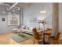 Stylish living room with hardwood floors, industrial-style concrete ceiling, and modern lighting at 1058 Piedmont Ne Ave # 302, Atlanta, GA 30309