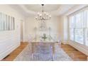 Elegant dining room with a large mirror table and hardwood floors at 3095 Bellingrath Blvd, Roswell, GA 30076