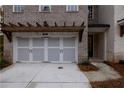 Two-car garage with light gray doors and pergola at 131 Wards Crossing Way # 19, Johns Creek, GA 30022