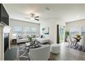 Open concept living and dining area with hardwood floors at 7788 Richmond Trl, Fairburn, GA 30213