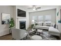 Spacious living room with a fireplace and L-shaped sofa at 7788 Richmond Trl, Fairburn, GA 30213