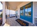 Inviting front porch with a swing and brick flooring at 4973 Concert Ln, Marietta, GA 30066