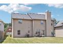 Two-story house with beige siding, a yard, and a patio at 709 Chapman St, Jonesboro, GA 30238