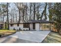 Recently renovated ranch home, featuring a white brick exterior and a covered carport at 1120 Starline Se Dr, Smyrna, GA 30080