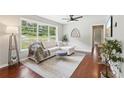 Comfortable living room featuring a modern sofa, area rug, and large window at 1120 Starline Se Dr, Smyrna, GA 30080
