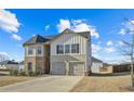 Two-story house with brick and siding, two-car garage, and a spacious driveway at 12 Enclave Blvd, Covington, GA 30014