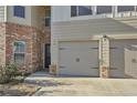 Two-car garage with gray doors and black hardware at 12 Enclave Blvd, Covington, GA 30014