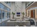Open living space with floor-to-ceiling windows and a marble fireplace at 55 Serendipity Way, Atlanta, GA 30350