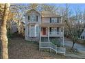 Two-story house with light beige siding, a wraparound porch, and a white railing at 2618 Windage Sw Dr, Marietta, GA 30008