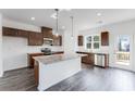 Modern kitchen features granite countertops, stainless appliances, and dark cabinets at 238 Lytham Se Dr, Mableton, GA 30126