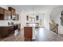 Kitchen with granite countertops, stainless appliances, and dark hardwood floors at 238 Lytham Se Dr, Mableton, GA 30126
