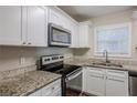 Modern kitchen with granite countertops and stainless steel appliances at 2839 Allegro Nw Dr, Atlanta, GA 30318
