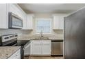 Modern kitchen with granite countertops and stainless steel appliances at 2839 Allegro Nw Dr, Atlanta, GA 30318