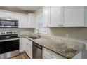 Modern kitchen with granite countertops and stainless steel appliances at 2839 Allegro Nw Dr, Atlanta, GA 30318