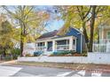 Charming blue house with white trim, front porch, and landscaped yard at 516 Arthur Sw St, Atlanta, GA 30310
