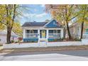 Charming blue house with white trim, front porch, and landscaped yard at 516 Arthur Sw St, Atlanta, GA 30310
