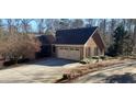 Two-car garage with a long driveway at 1030 Lake Haynes Ne Dr, Conyers, GA 30012