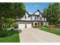 Beautiful two-story home with a three-car garage and manicured lawn at 7108 Roselake Cir, Douglasville, GA 30134