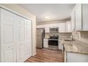 Modern kitchen with white cabinets, granite counters, and stainless steel appliances at 3519 Adkins Nw Rd, Atlanta, GA 30331