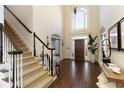 Two-story foyer with hardwood floors, a grand staircase, and large windows at 420 Autry Mill Cir, Alpharetta, GA 30022