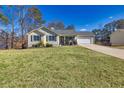 Charming house with a spacious lawn and attached garage at 775 Holcombe Woods Ct, Auburn, GA 30011