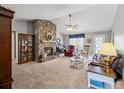 Spacious living room featuring a stone fireplace and comfortable seating at 775 Holcombe Woods Ct, Auburn, GA 30011