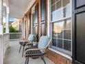Inviting front porch with two wicker chairs and plants at 2750 Olde Towne Pkwy, Duluth, GA 30097