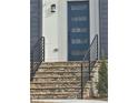 Close-up of front entrance with stone steps and a modern blue door with glass inserts at 503 Glendale Rd, Scottdale, GA 30079