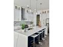 Bright, modern kitchen with white cabinets, a large island, stainless steel appliances and barstool seating at 503 Glendale Rd, Scottdale, GA 30079