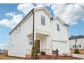 Two-story home with white siding, a two-car garage, and a manicured front lawn at 2024 Avalon Rdg, Conyers, GA 30013