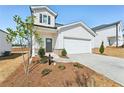 Inviting two-story home with a manicured front yard and a spacious two-car garage at 2026 Avalon Rdg, Conyers, GA 30013