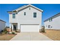 Two story home featuring a two car garage, light gray siding and a concrete driveway at 2032 Avalon Rdg, Conyers, GA 30013